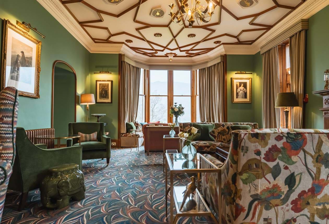 Luxury lounge at The Torridon hotel in the Scottish Highlands with ornate ceiling and soft seating