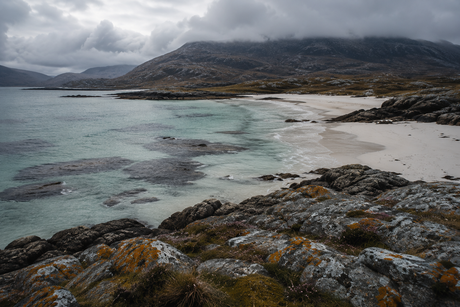 Turquoise waters, white sands and lichen-covered coastal rocks on Scotland's west coast, reflecting the colours of Araminta Campbell's West Coast Waters tartan.