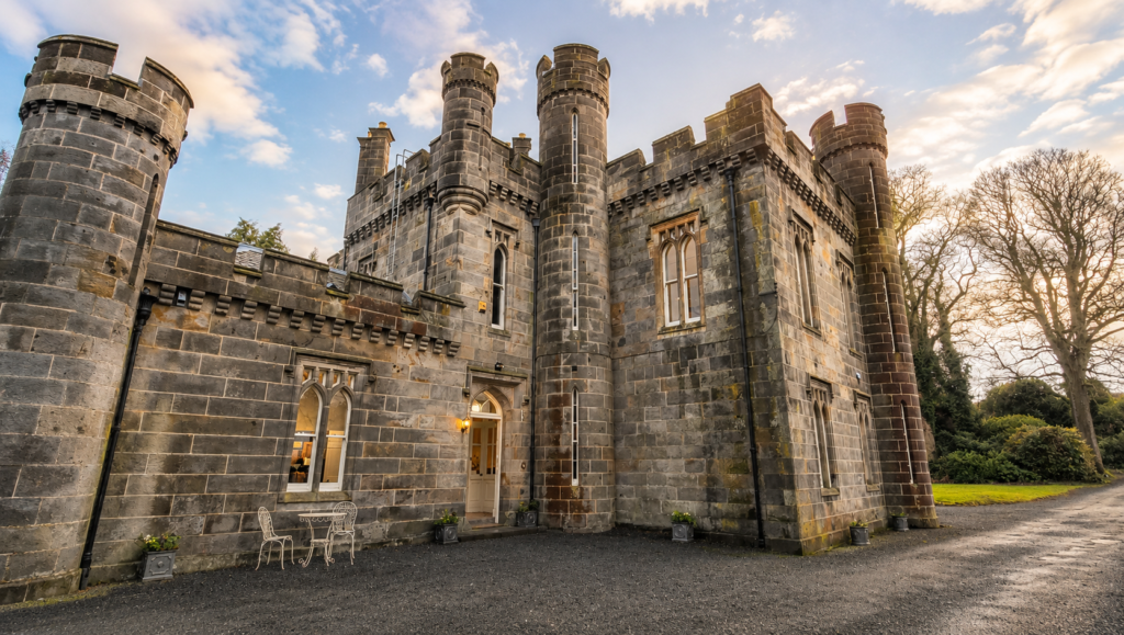 Exterior view of the Araminta Campbell atelier in Edinburgh, a historic Scottish castle-style building with Gothic architecture and stone towers.
